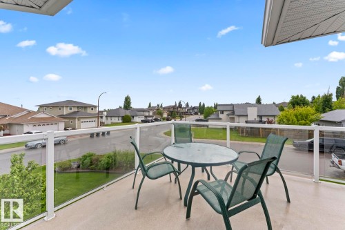 Outdoor balcony with a glass railing system and a textured concrete surface - 2602 Delta Road, Cold Lake, AB 