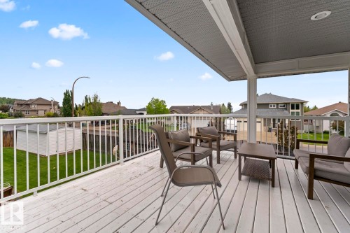 Spacious covered deck featuring painted wood-finish flooring and white perimeter railing - 2602 Delta Road, Cold Lake, AB 