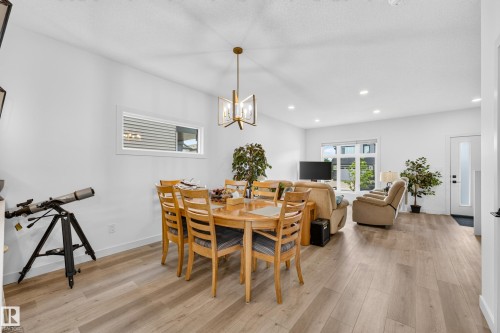 Open concept living space with light wood-finish flooring - 104 Kidd Crescent, Leduc, AB 