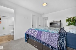 Carpeted bedroom with a flat white ceiling and a flush-mount light fixture - 