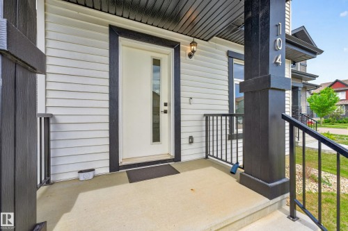 Modern white exterior with dark trim and accents - 104 Kidd Crescent, Leduc, AB 