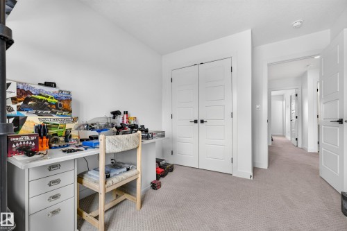 Neutral-toned carpeting and bright white walls provide a versatile backdrop - 104 Kidd Crescent, Leduc, AB 