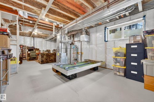 Unfinished basement offering expansive open space, exposed ceiling joists, and a perimeter foundation wall with insulation - 104 Kidd Crescent, Leduc, AB 