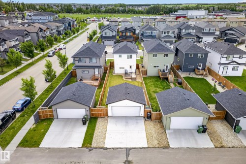 Modern detached single-family home featuring a two-story design, a private rear yard, and a detached two-car garage with a concrete driveway - 104 Kidd Crescent, Leduc, AB 