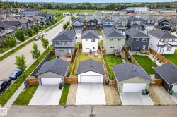 Modern detached single-family home featuring a two-story design, a private rear yard, and a detached two-car garage with a concrete driveway - 