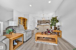 Open-concept living space featuring wood-finish flooring and recessed ceiling lights - 
