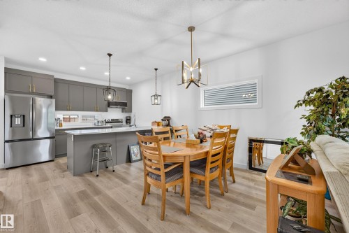 Open concept living area featuring wood-finish flooring - 104 Kidd Crescent, Leduc, AB 