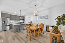 Open concept living area featuring wood-finish flooring - 