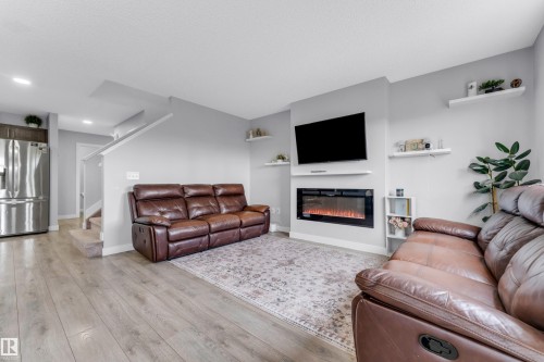 Living area with wood-finish flooring and light gray walls - 1750 27 Street, Edmonton, AB 