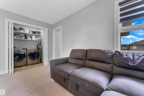 Integrated laundry closet with bi-fold doors and built-in shelving - 1750 27 Street, Edmonton, AB 