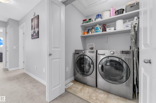 Dedicated laundry area featuring front-loading appliances - 1750 27 Street, Edmonton, AB 