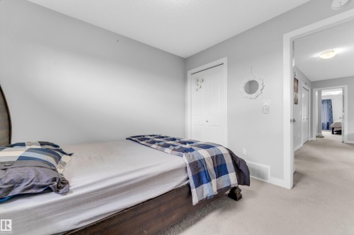 Light grey painted walls with white trim and a neutral carpeted floor - 1750 27 Street, Edmonton, AB 