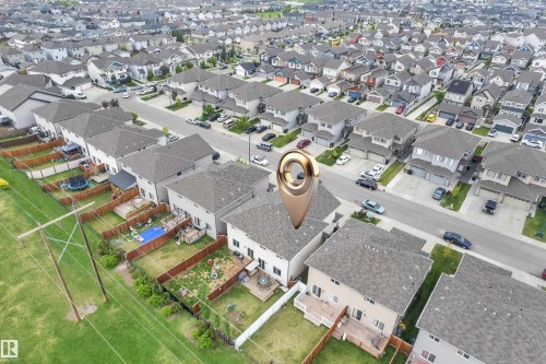 Aerial view of a residential community featuring numerous single-family homes with gray shingle roofs - 1750 27 Street, Edmonton, AB 