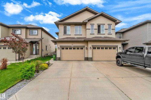 Two-story residence featuring light-toned siding and a prominent gable roofline - 1750 27 Street, Edmonton, AB 