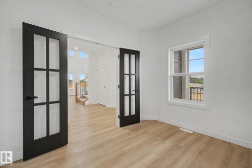 Room featuring light wood-finish flooring and white walls - 4 Willow Heights Drive, Stony Plain, AB 