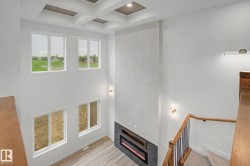 Two-story architectural wall featuring an integrated linear electric fireplace with a dark tile surround - 