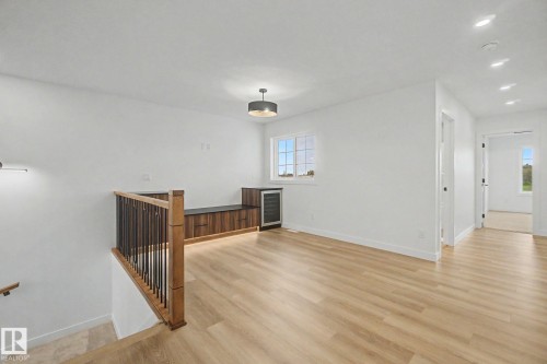 Open concept upper-level space featuring light wood-finish flooring and crisp white walls - 4 Willow Heights Drive, Stony Plain, AB 