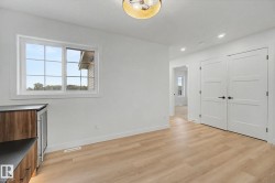 Bright interior room with wood-finish flooring - 