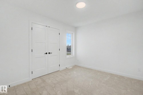 Bright room featuring neutral carpeting and white walls - 4 Willow Heights Drive, Stony Plain, AB 