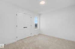 Bright room featuring neutral carpeting and white walls - 