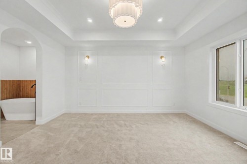 Recessed ceiling with an ornate semi-flush mount light fixture and additional recessed lighting - 4 Willow Heights Drive, Stony Plain, AB 