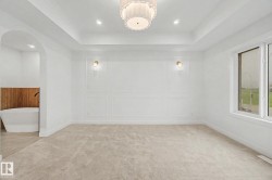 Recessed ceiling with an ornate semi-flush mount light fixture and additional recessed lighting - 