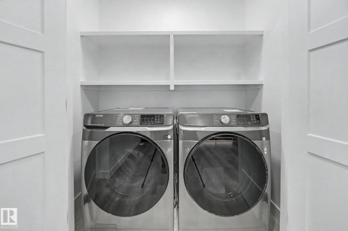Dedicated laundry area featuring a front-loading washer and dryer set - 4 Willow Heights Drive, Stony Plain, AB 