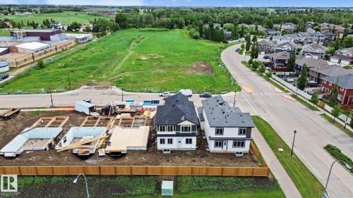 Aerial perspective showcasing new residential construction with two completed homes and three additional foundations - 4 Willow Heights Drive, Stony Plain, AB 