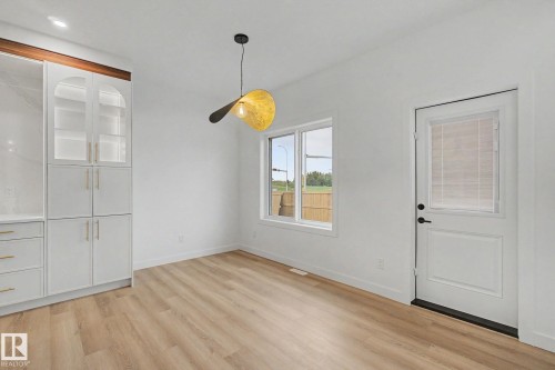 Bright room featuring wood-finish flooring and white walls - 4 Willow Heights Drive, Stony Plain, AB 