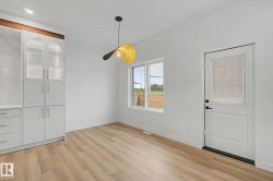 Bright room featuring wood-finish flooring and white walls - 