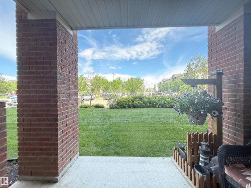Covered porch with exposed brick columns and a smooth concrete floor - 117 3715 Whitelaw Lane, Edmonton, AB 