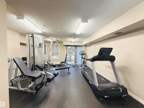 Dedicated fitness room featuring rubber flooring, recessed lighting, and sliding glass doors - 117 3715 Whitelaw Lane, Edmonton, AB 