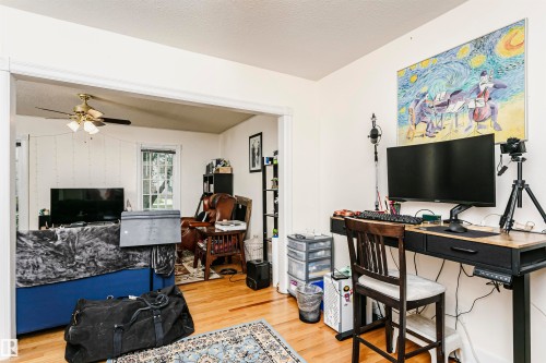 Hardwood-style flooring extends through an open doorway, connecting two distinct areas - 11105 81 Avenue, Edmonton, AB 