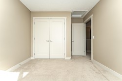 Neutral-toned interior with light tan walls, white trim, and light beige carpeting - 