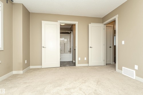 Carpeted room with neutral wall paint and white trim - 2397 Glenridding Boulevard, Edmonton, AB 