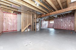 Unfinished basement offering exposed wood framing, insulated walls, and a concrete floor - 