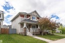 Multi-level exterior featuring stone veneer accents, light siding, and a covered front porch with white railings - 2397 Glenridding Boulevard, Edmonton, AB 