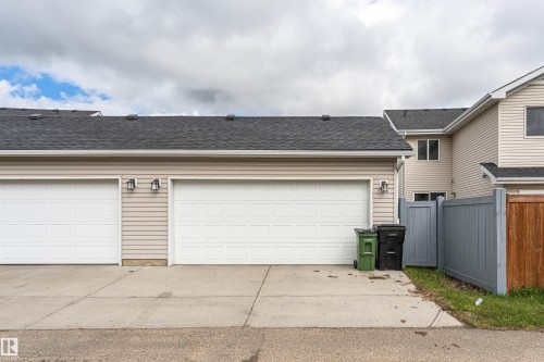 Two-car detached garage with panel doors and light beige horizontal siding - 2397 Glenridding Boulevard, Edmonton, AB 
