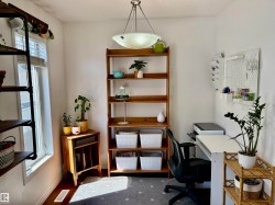 Bright room with white walls, wood-finish flooring, and a window with blinds - 