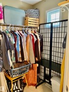 Closet space featuring wire shelving, a window providing natural light, and neutral-toned walls - 