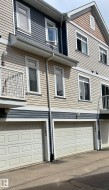 Multi-level townhouse exterior featuring horizontal siding and decorative shingles - 