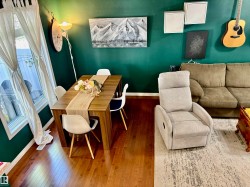 Dining area with wood-finish flooring and a rectangular dining table - 