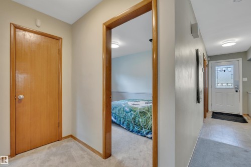 Hallway with light-colored walls and carpeted flooring - 9835 74 Street, Edmonton, AB 