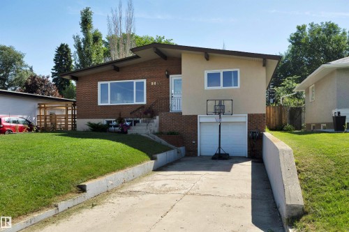 Brick and stucco exterior with white-framed windows - 9835 74 Street, Edmonton, AB 