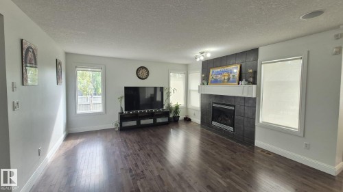 5440 1A Avenue, Edmonton, AB - Indoor Photo Showing Living Room With Fireplace