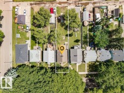 Residential property featuring a rectangular lot, mature trees, and a detached structure - 