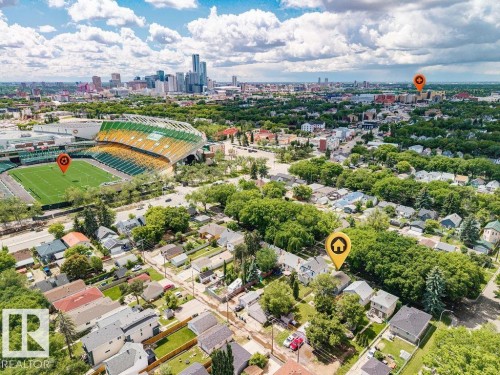 Aerial perspective showcasing residential properties with a stadium visible in the background - 11241 88 Street, Edmonton, AB 