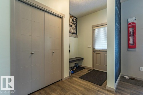 Entryway featuring light wood-finish flooring and neutral wall tones - 17123 49 Street, Edmonton, AB 