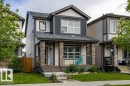 Two-story residence featuring a covered front porch with stone-clad pillars - 17123 49 Street, Edmonton, AB 