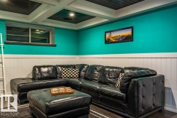 Coffered ceiling with dark panels and recessed lighting - 